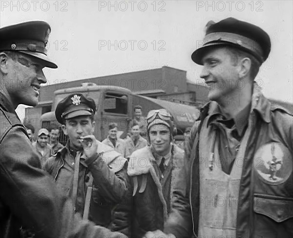 A Male Pilot Shaking Hands with an Officer, whilst other Pilots are Looking On, 1943-1944. Creator: British Pathe Ltd.