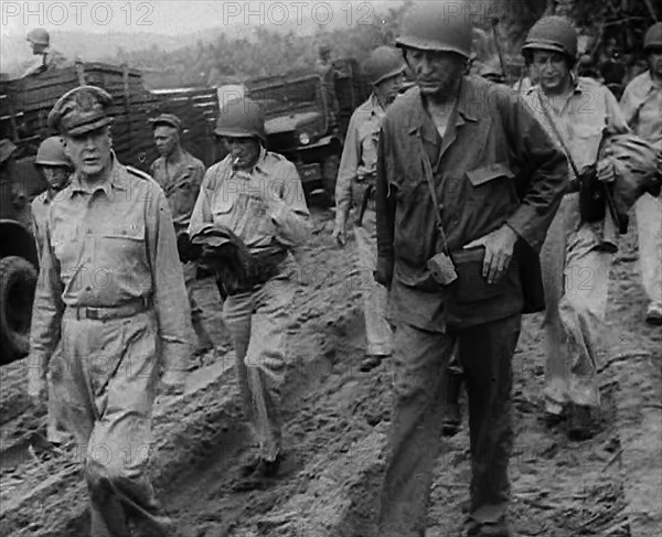 General Douglas MacArthur Walking With American Troops in the Pacific Campaign, 1943. Creator: British Pathe Ltd.