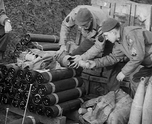 Allied Soldiers Loading Leaflets, Calling the Enemy to Surrender Into an Artillery Shell, 1943-1944. Creator: British Pathe Ltd.