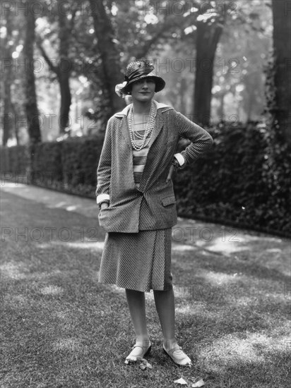 Coco Chanel modeling a Chanel suit on rue Faubourg Saint-Honoré in Paris, 1929, 1929. Creator: Sasha; (Alexander Stewart) (1892-1953).