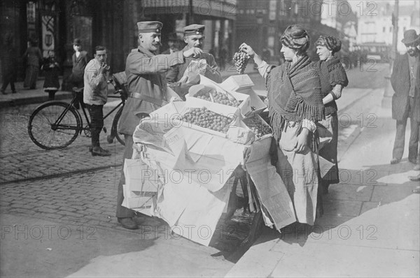 German soldiers buying fruit, Belgium, 1915. Creator: Bain News Service.