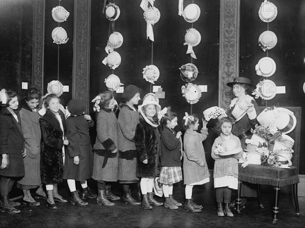 Natalie Stewart Distributing hats to poor children, between c1915 and c1920. Creator: Bain News Service.