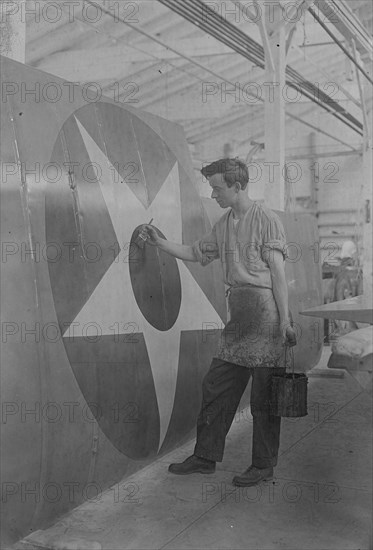 Putting U.S. Emblem on plane, between c1915 and c1920. Creator: Bain News Service.