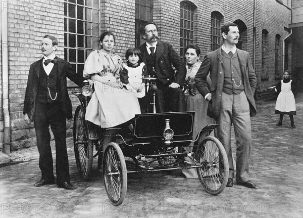 Carl Benz with his family at his Benz Velo in the Mannheim factory yard, 1894. Creator: Anonymous.