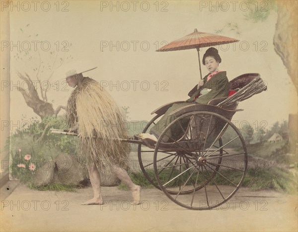 Woman with Parasol Posed Being Pulled in a Jinrikisha by a Man Wearing a Straw Rain Coat,1870s-1890s Creator: Kusakabe Kimbei.