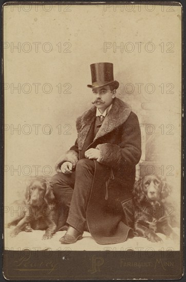 Portrait of a Moustachioed Seated Man in Top Hat and Winter, Fur-Collared Coat..., about 1890. Creator: Lewis Peavey.