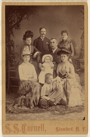 Group family portrait of eight members, 1889. Creator: SS Cornell.