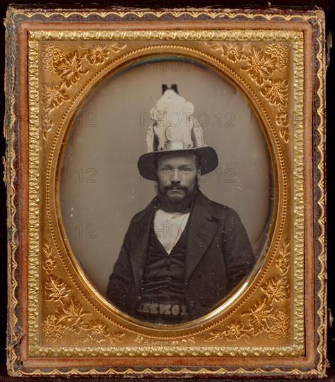 Portrait of a Seated Bearded Man Wearing a Tall, Decorative Helmet, about 1854. Creator: George D. Hamilton.