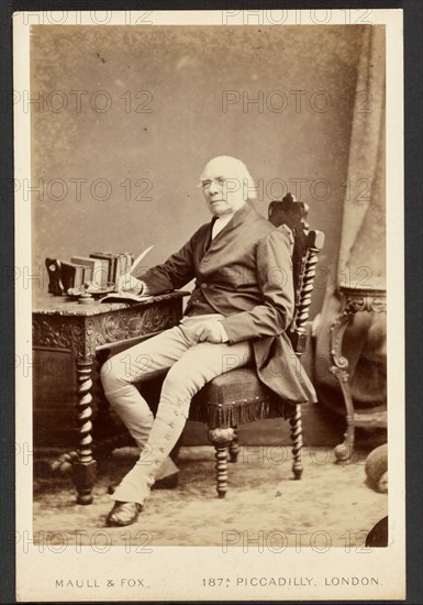 Portrait of man holding quill, about 1879-1885. Creator: Maull & Fox.