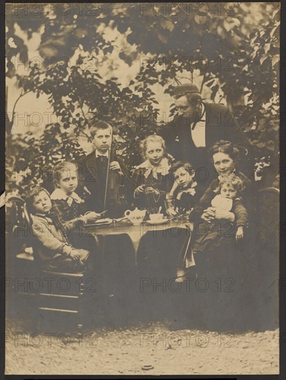 Group portrait around table, 1880-1890. Creator: Victor Dix.