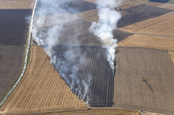 Fires in an arable field engulfing an electricty pylon, Amcotts, North Lincolnshire, 2022. Creator: Emma Trevarthen.