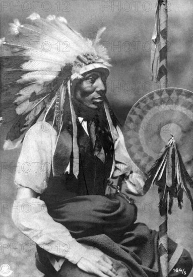Photo card representing a young sitting Indian