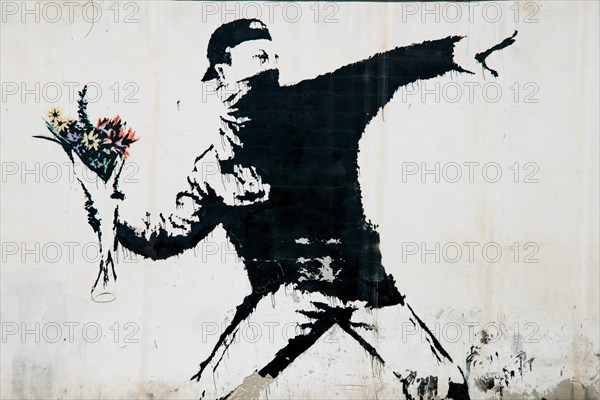 A mural by the artist Banksy covers a wall in the Wests Bank village of Beit Sahour, June 18, 2014.