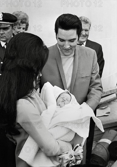 Elvis Presley, Priscilla Presley,  leaving the Baptist Hospital, Memphis, Tennessee, with their daughter Lisa-Marie, born at the hospital on February 1, 1968.  File Reference # 33635_680CPC