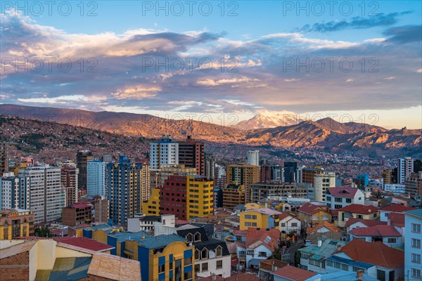 La Paz cityscape including Illimani mountain and residential buildings at sunset in Bolivia, South America.