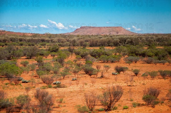 Desert landscape seen from The Ghan train south of Alice Springs, Northern Territory, Australia