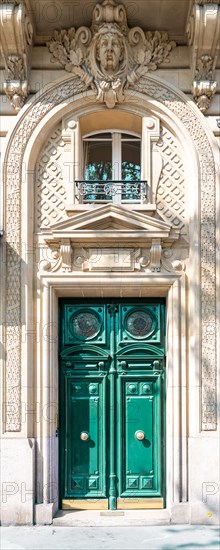 Paris, an ancient wooden door, typical building in the center