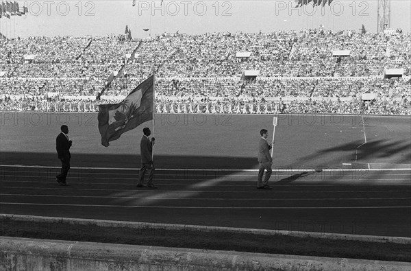 Olympic Games in Rome. Opening. Entry of the athletes in the Olympic Stadium. [The delegation of Haiti consists of one athlete, weightlifter Philomene Lagurre and delegation head Pierre Plaisimond] Annotation: During his race he succeeded only pressing one weight Date: August 25, 1960 Location: Rome Keywords: athletes, openings Institution Name: Olympic Stadium  : Pot, Harry / Anefo Copyright Holder: National Archives Material Type: Negative (black / white) archive inventory number: see access 2.24.01.05