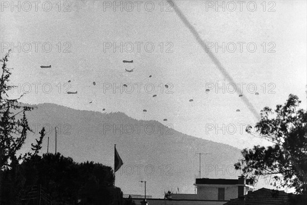 Following the successful Greek coup, which saw the overthrow of President Makarios of Cyprus, Turkey has launched an invasion of the Mediterranean holiday isle. Many tourists are among civilians who have been forced to take shelter in hotels in the capital, Nicosia. The Turkish invasion begins ... a dramatic picture of Turkish paratroops landing near Nicosia. ;July 1974 ;P004305