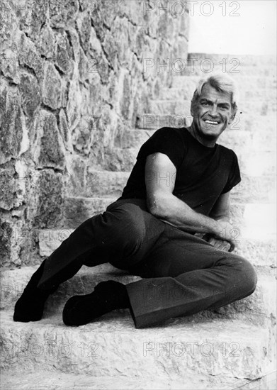 Portrait of actor Jean Marais on stone steps