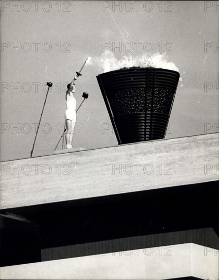 Nov. 10, 1964 - Opening Of The Olympic Games In Tokyo: The 1964 Olympic Games was officially opened yesterday at Tokyo, as 7,000 athletes from 94 nations marched in ceremonial parade in the National Stadium. Photo shows: University student, 19-year old Yoshinari Sakia, who was born in Hiroshima on the day the atomic bomb was dropped -seen kindling the Olympic flame at yesterday's opening ceremony in Tokyo.