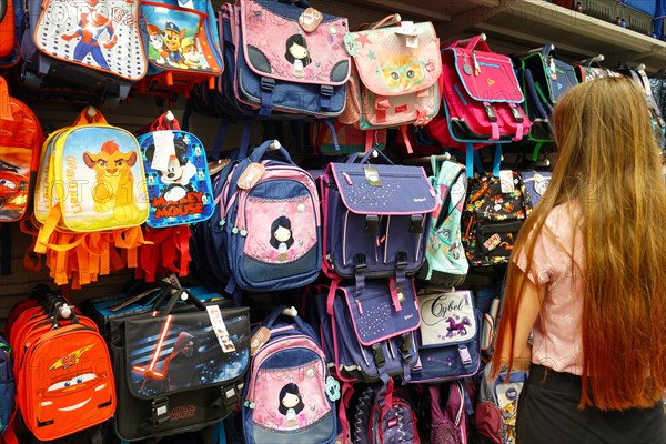 Colorful school backpacks on display for sale in a store