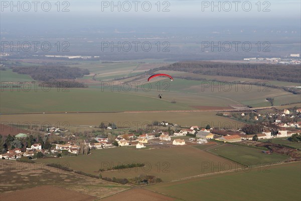 Aerial view of a paramotor flying over the commune of Soindres in the Yvelines department (78200), Ile-de-France region, France - January 03, 2010