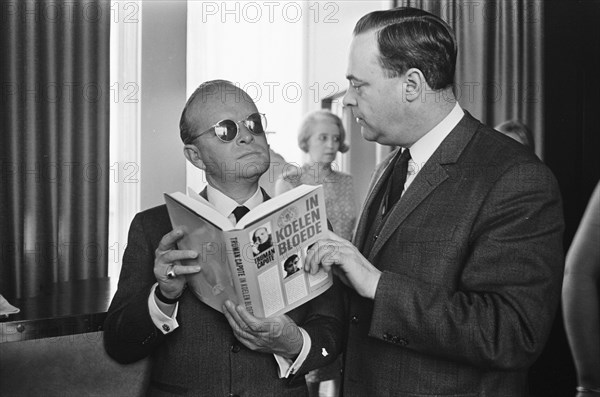 Film premiere at Du Midi, In Koelen Bloede (In Cold Blood) based on the book by Truman Capote. The author (left) shows his book, March 14, 1968, authors, cinemas, books, films, premieres, directors, writers, The Netherlands, 20th century press agency photo, news to remember, documentary, historic photography 1945-1990, visual stories, human history of the Twentieth Century, capturing moments in time