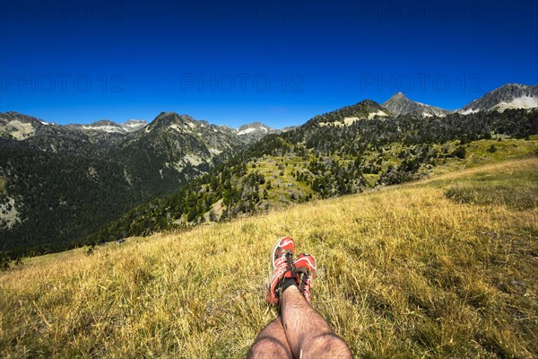 Landscape and legs during mountain hiking at Pyrenean mountain