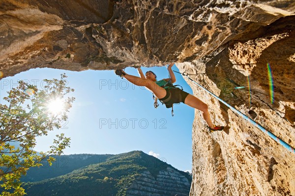 woman climbing out of a cave at the French Riviera