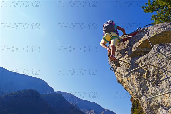 climber on a steep rock face, Via Ferrata, France, Savoie, Maurienne, Saint-Colomban-les-Villards