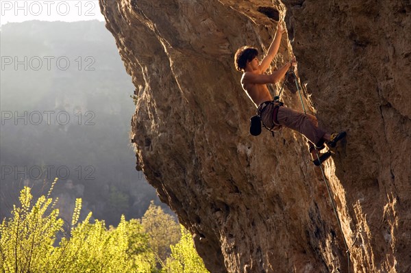 A climber tackles Dromadaire by the Tarn river, Gorges du Tarn, near Millau and Rodez, Massif Central, France