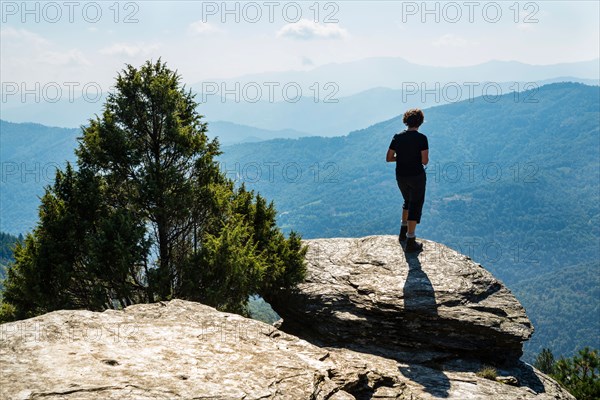 Walker contemplating the view from the Fontmort hills on the Robert Louis Stevenson Trail in the Cévennes, Lozère, France