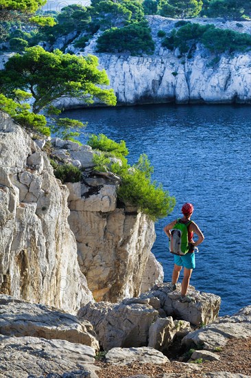 female wanderer looking at the rocky coast of Calanques, France, Provence, Calanques National Park, Marseille Cassis La Ciotat