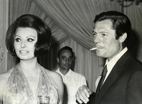 Italian actors Marcello Mastroianni and Sophia Loren at a reception