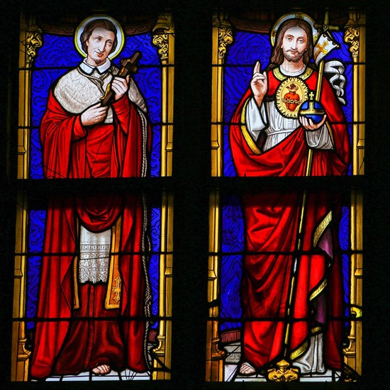 Stained Glass window in the 15th Century Elzenveld Chapel in Antwerp, Belgium, depicting Jesus Christ and Saint Charles Borromeo