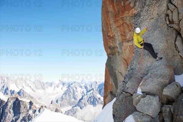 Mountaineer using climbing rope, Chamonix, Haute Savoie, France