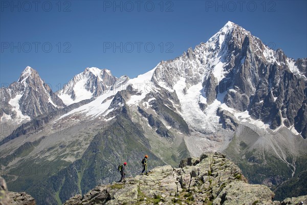 Two mountaineers on a rocky ridge high above Chamonix in the French Alps.