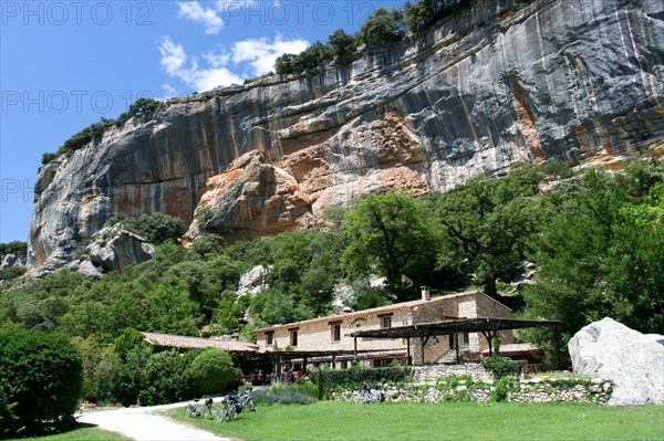 Buoux, France - June 26 2007: cyclists eat in restaurant of Auberge under the cliffs of the buoux fort, France. Auberges are rural Inns typically with