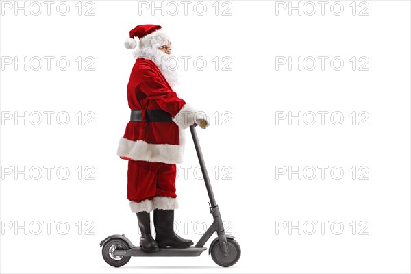 Full length portrait of Santa Claus riding an electric scooter isolated on white background