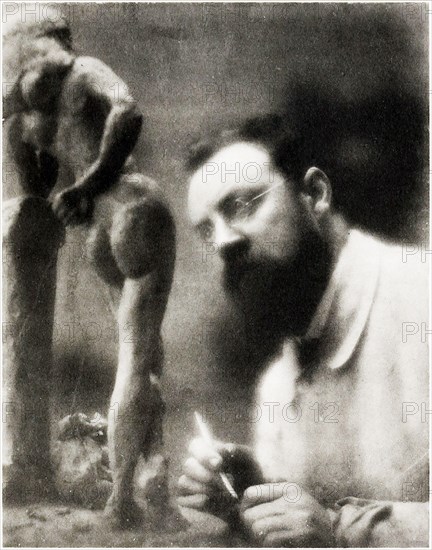 Old photo / portrait of the world famous artist, Henri Matisse sculpturing