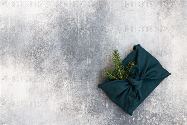 Furoshiki style gift for Christmas or New Year on a white background. Flat lay. Copy space.