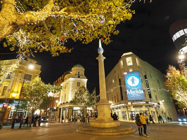 View of the London Seven Dials road junction decorated at night for Christmas