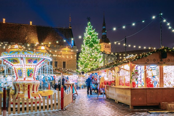 Tallinn, Estonia. Traditional Christmas Market On Town Hall Square. Christmas Tree And Trading Houses. Happy New Year Holiday.