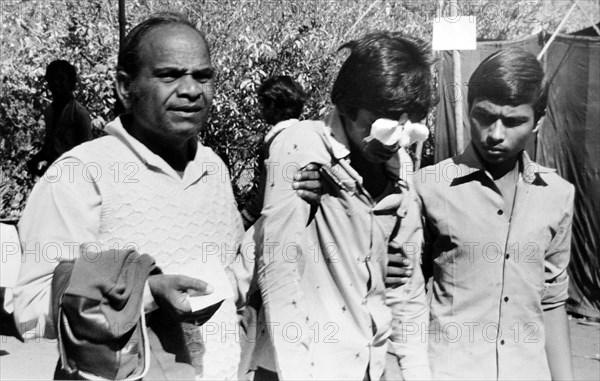 Father with son eyes bandage damaged , Bhopal , Madhya Pradesh , India , Asia