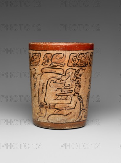 Cylindrical Vessel 7th–8th century Maya This cylindrical vessel framed by red bands contains a hieroglyphic text around its rim and shows two seated gods. It is painted in the ‘codex-style’, and the artist used simple shading to emphasize the two figures. The deities could be a version of K’awiil, the Maya god of lightning, as evidenced by the smoking scrolls emerging from their foreheads. ‘Codex-style’ pots are so-called for the style of painting which bears a close resemblance to the four extant screen-fold Maya books, known as codices, located in Madrid, Paris, Dresden, and Mexico City. The