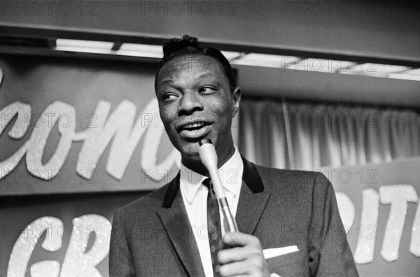 Nat King Cole, American singer, and pianist performing in London.   He flew in earlier in the day from his European tour. Picture taken 12th May 1960