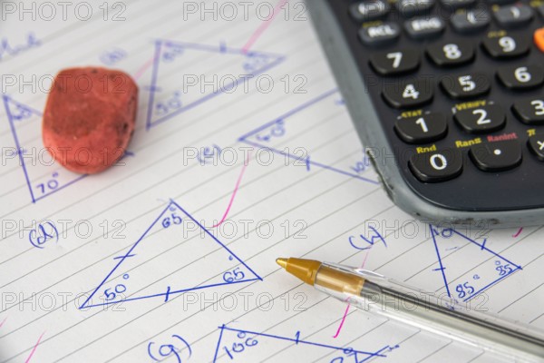 A Child's Math (Geometry) Homework Or Exam, With Calculator, Pen And Eraser