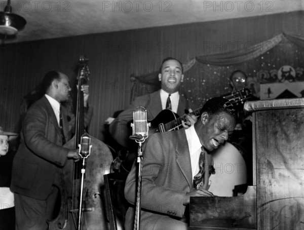 Jazz being played! Portrait of Wesley Prince, Oscar Moore, and Nat King Cole, Zanzibar, Live on stage - New York, N.Y., ca. July 1946 - photo by Gottlieb