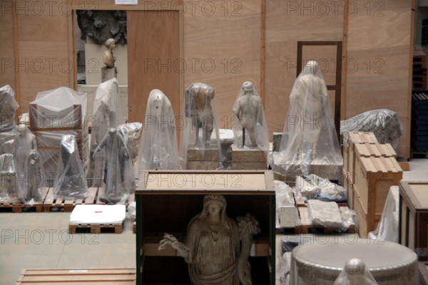 packed statues at the louvre museum in paris france